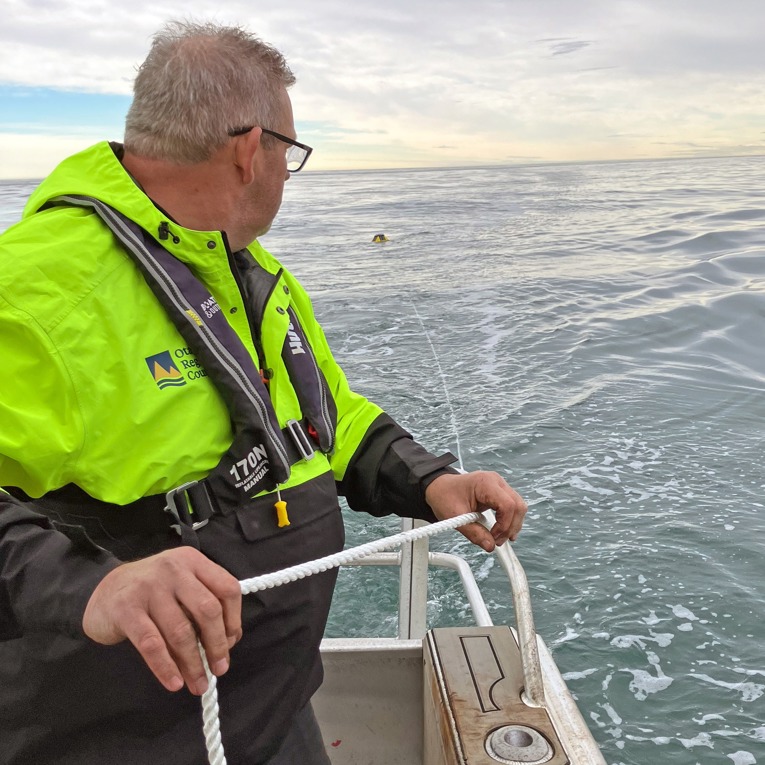 ORC Harbourmaster Steve deploying a buoy that records wave information.